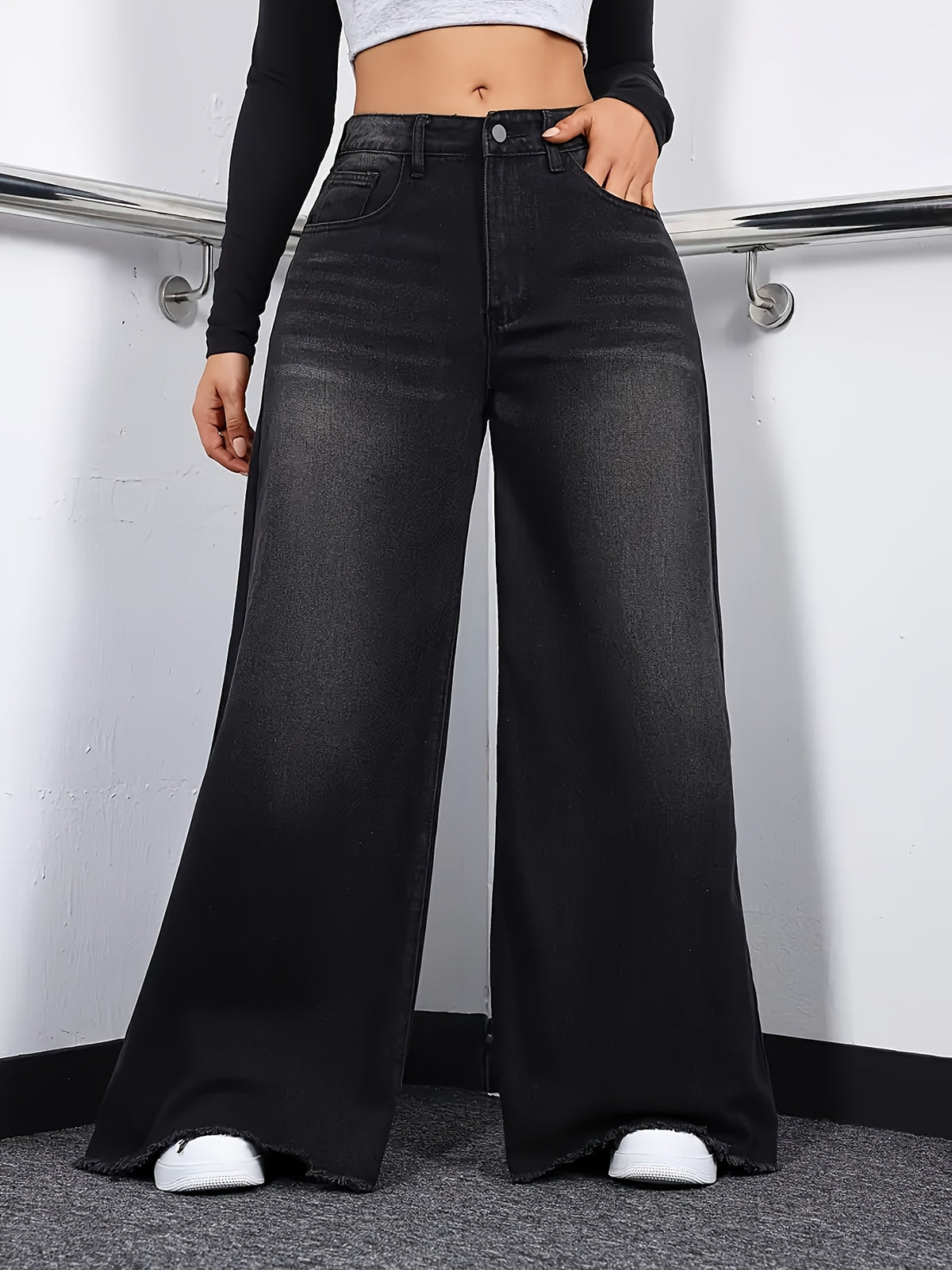 Jean grande taille, coupe évasée, tenue franche, ourlet effiloché, porté de face