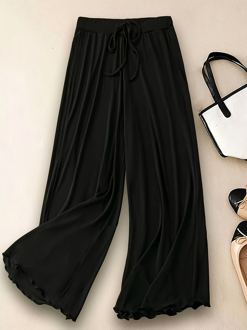 Pantalon fluide grande taille — Maille noire, ourlet ondulé