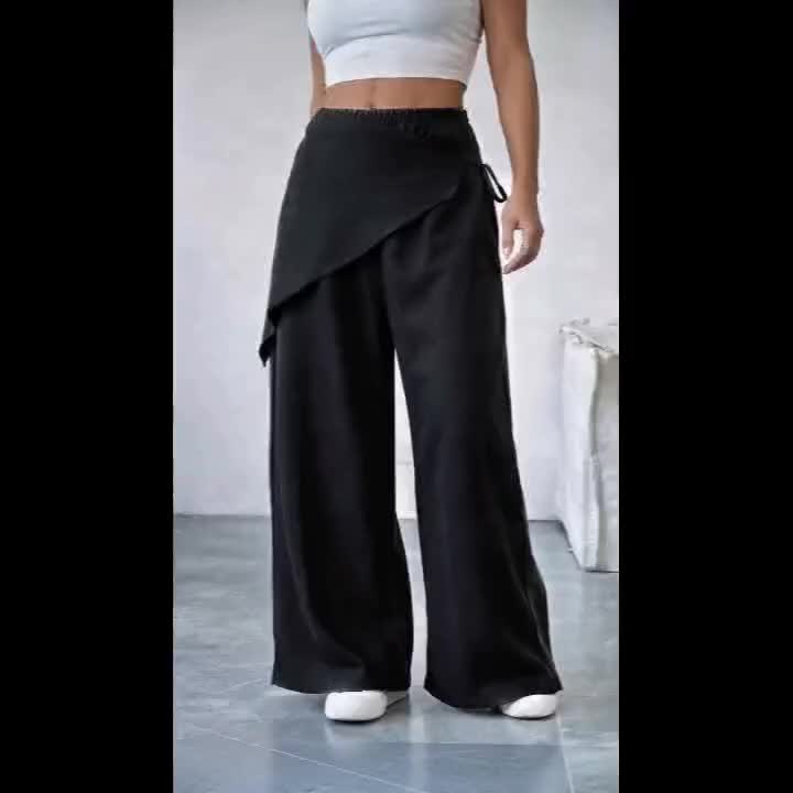 Pantalon noir grande taille — Pan drapé croisé sur le devant